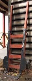 Wooden frame and metal supports; wood is painted orange
