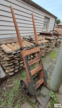 Wood and metal hand trolley with curved metal side flanges, painted orange