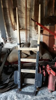 Hand trolley has metal platform and flanges to secure the load