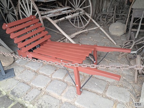 Trolley's base is at an angle and has one wheel as in a wheelbarrow. 