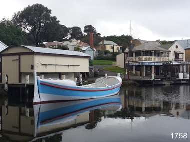 Lifeboat Warrnambool, painted white and blue, on the lake beside the Rocket House