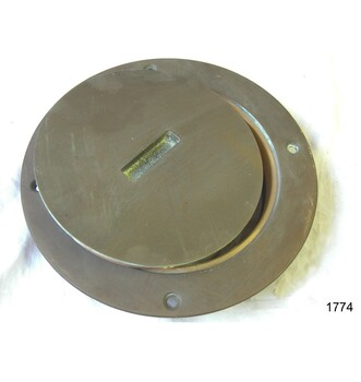 Brass inspection plate frame and lid. Lid has a concave groove in the centre