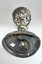 buckled base has a white sticker. Underside of bowl has decorative cut metal pattern.