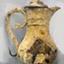 Cruet with heavily encrusted surface. Surface is corroded. 