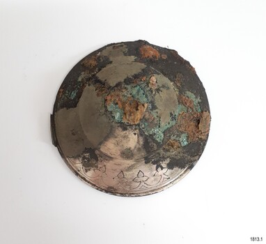 Round domed lid with encrustation of black, brown and green