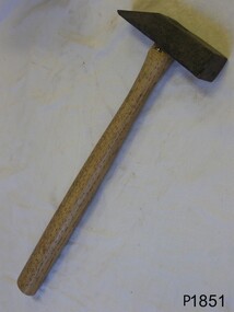 Metal hammer with wooden handle. The head is pointed on one side, flat on the other.