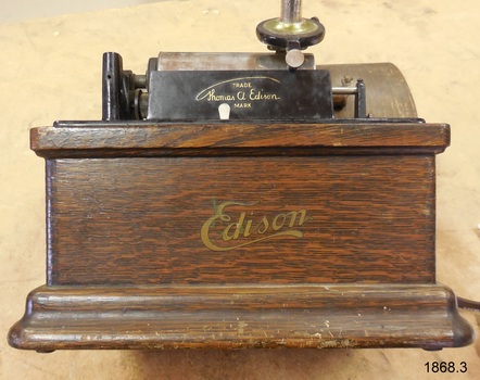 Both the wooden case and the machine have gold decals with maker's details