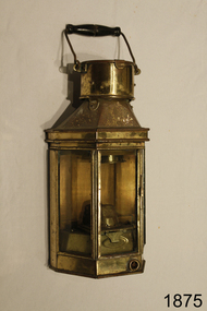 Brass lamp with three glass windows and wood and metal folding carry hadle