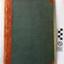 Green hard covered book with red spine and reinforced corners.