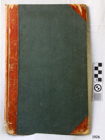 Green hard covered book with red spine and reinforced corners.