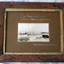Timber framed photograph of a sailing ship stranded close to shore