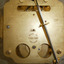 Inscriptions with text and numbers are stamped on the backplate of the clock mechanism