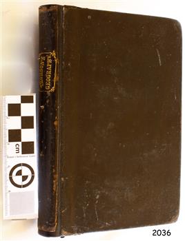 Black covered book with gold embossed text on the spine