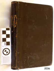 Black covered book with gold embossed text on the spine