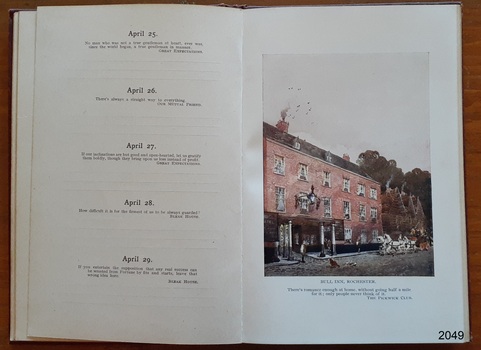 Left page has dates with sayings, right page has a street scene