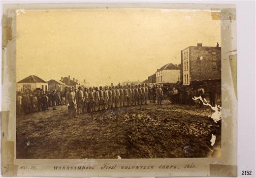 Warrnambool First Volunteer Corps. 1860, in formation on a road between buildings