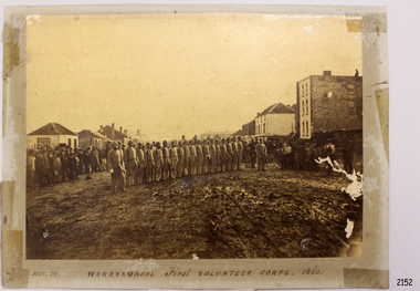 Warrnambool First Volunteer Corps. 1860, in formation on a road between buildings