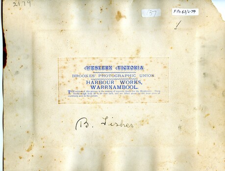 Reverse of photograph has three labels, one is photographer's details. also has hand written inscription