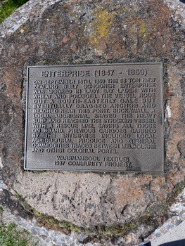 Impressed rectangular metal plaque mounted on concrete 