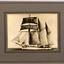 Sepia photograph mounded on card that has a printed border. Subject of ship in full sail