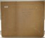 Brown card with white sticker and pencil inscriptions
