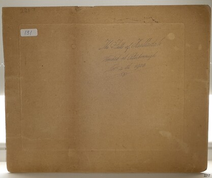 Brown card with white sticker and pencil inscriptions