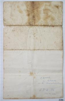 Back page with hand writing in lower right corner and stains on top of paper