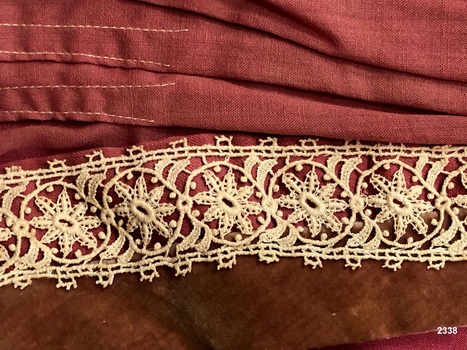 Close up view of lace and velvet on ladies bodice.