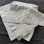 Long rectangle of white clothe with a wide hem.
