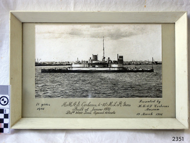 Ship in foreground, docked, buildings in background. Gift to H.M.A.S. Cerberus Museum