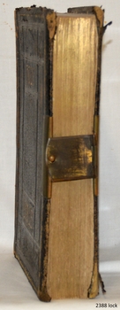 Pages have gold leave edges. a metal clasp holds the centre of front and back covers together 