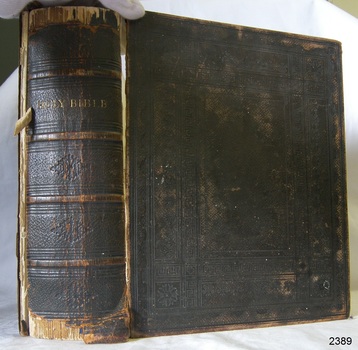 Embossed fabric covered hard cover Bible with gold lettering