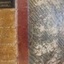Hard covered bound book with patterned cover and leather spine with gild embossed title