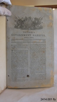 Gazette open at fly page, showing government crest and two columns of text