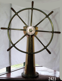 Brass ship's wheel with conical pedestal and eight spokes
