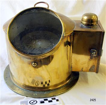 Brass housing with a ship's compass and lamp cover