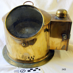 Brass housing with a ship's compass and lamp cover