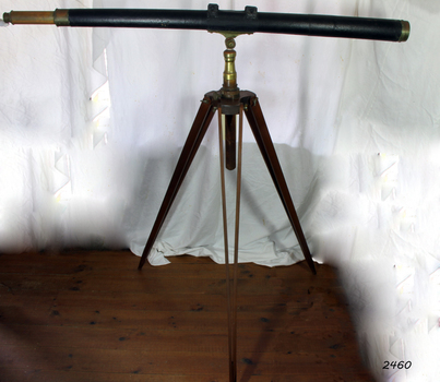 Wood and metal long telescope mounted on a wooden tripod