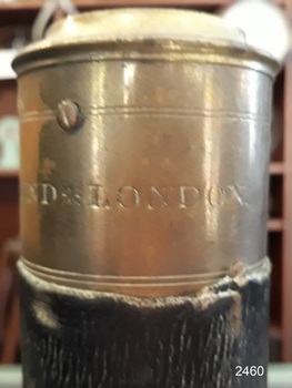 Maker's name stamped into the brass fitting around the end