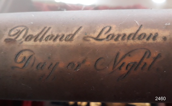 Engraved inscription in cursive script "Dollond London, Day or Night"