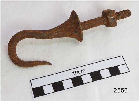 Pointed metal hook that flares out at base and has a threaded shank with a nut attached