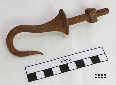 Pointed metal hook that flares out at base and has a threaded shank with a nut attached
