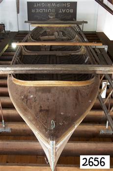 Wooden boat with suspended seats and positions for feet
