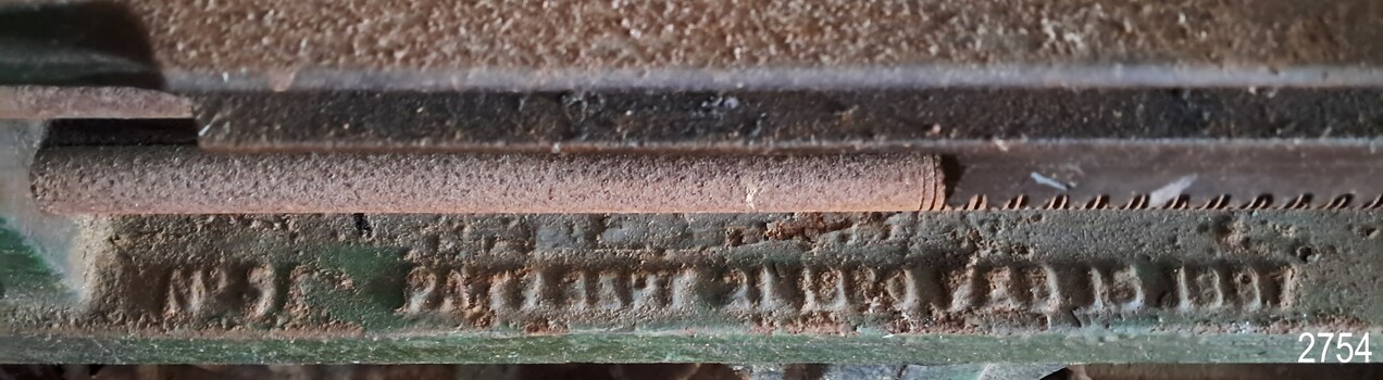 Letters and numbers cast into the metal machine bed