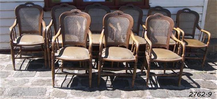 Chairs with wooden arms, turned spindle legs and arm supports, leather seats and wicker backs