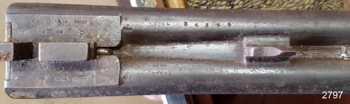 Close-up of shotgun parts, showing inscriptions