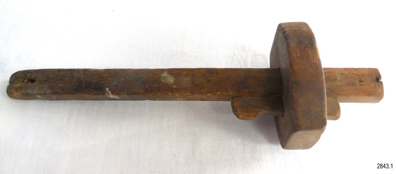Section of two wedges can be seen. These hold the block onto the shank.