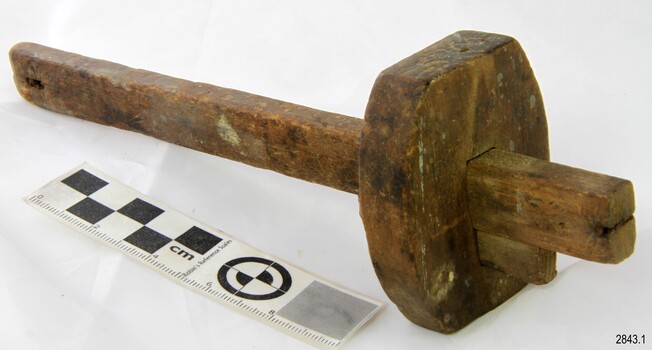 Wooden gauge with a slot in each end of the shank. The block has a wedge to hold it in position.