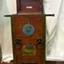 Mahogany box shaped case with dial on front and machinery within.