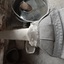 The nozzle of the bellows is blowing into the forge, showing the joint of the nozzle and bellows.